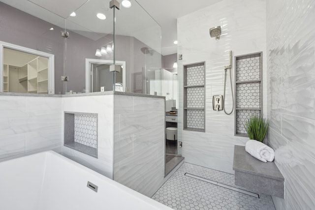 full bathroom with a soaking tub, tile walls, and tiled shower