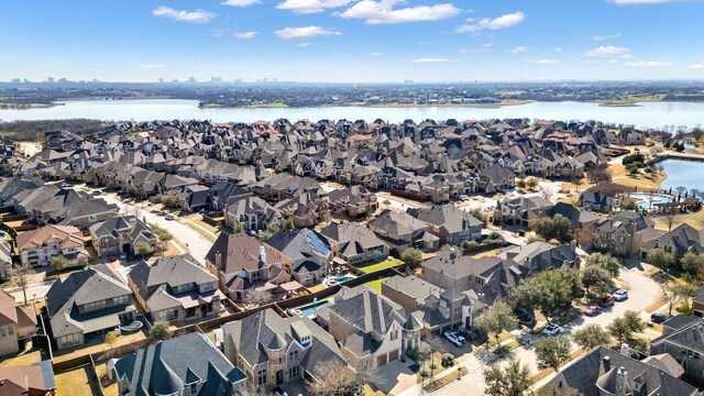 drone / aerial view with a residential view and a water view