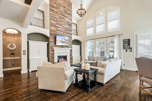 living area featuring dark wood finished floors, a fireplace, and baseboards