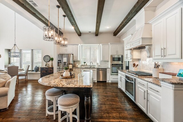 kitchen with visible vents, an inviting chandelier, stainless steel appliances, white cabinets, and a kitchen bar