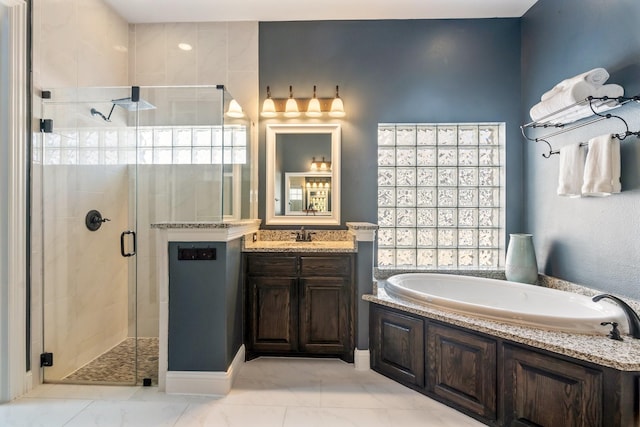 bathroom featuring a shower stall, vanity, and a garden tub