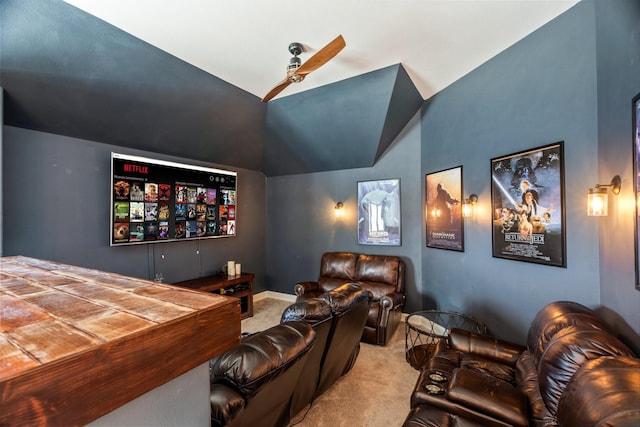 home theater featuring a ceiling fan, vaulted ceiling, and carpet