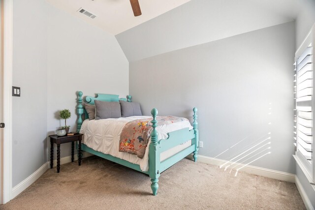 bedroom featuring vaulted ceiling, visible vents, baseboards, and carpet floors