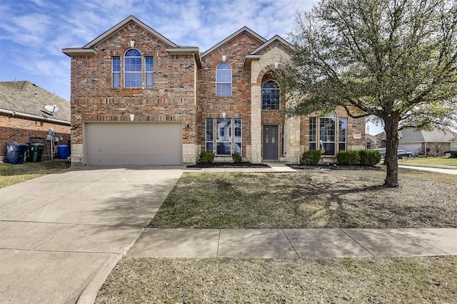 traditional-style home with stone siding, a garage, brick siding, and driveway