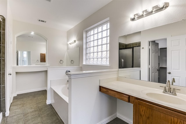 full bath with visible vents, baseboards, a garden tub, tile patterned floors, and vanity