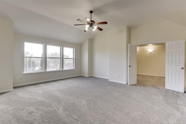 unfurnished room with visible vents, baseboards, carpet, ceiling fan, and vaulted ceiling