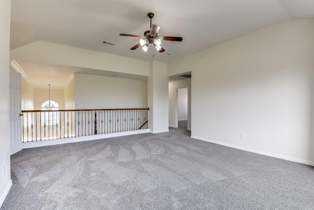 unfurnished room with carpet, baseboards, visible vents, ceiling fan, and vaulted ceiling