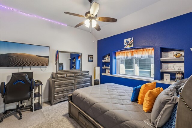 bedroom featuring lofted ceiling, carpet, baseboards, and ceiling fan