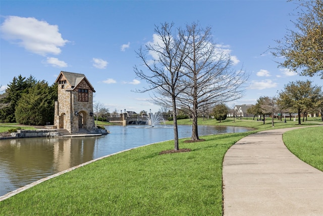 surrounding community featuring a yard and a water view