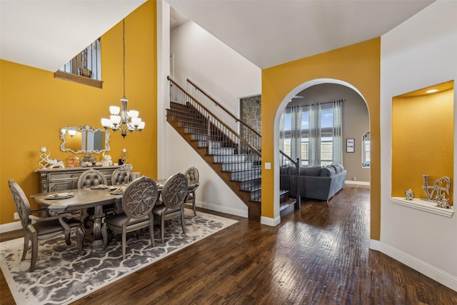 dining space featuring stairway, baseboards, and wood-type flooring