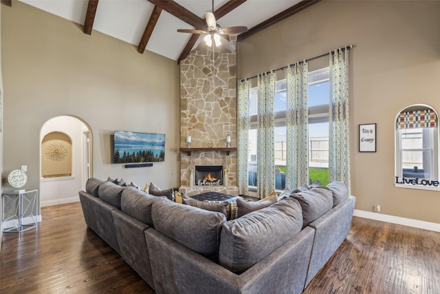 living area featuring beam ceiling, plenty of natural light, wood finished floors, and high vaulted ceiling