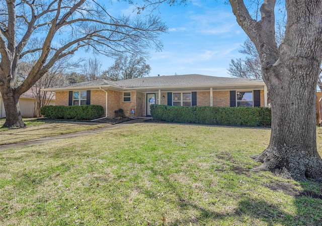 ranch-style home with brick siding and a front lawn