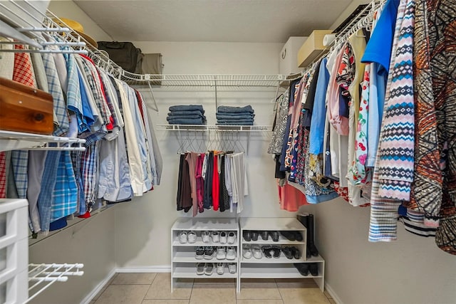 spacious closet featuring tile patterned flooring