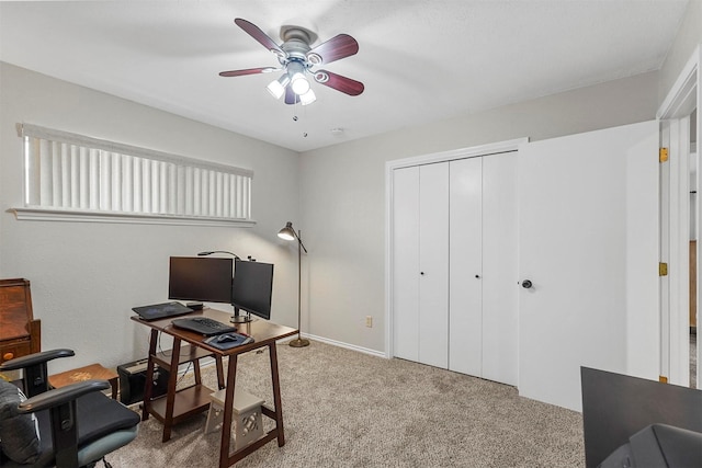 carpeted office featuring ceiling fan