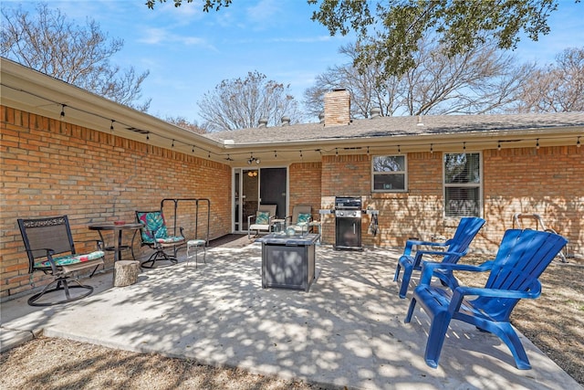 view of patio / terrace featuring a grill and an outdoor fire pit