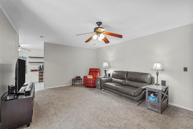 carpeted living area featuring baseboards and ceiling fan