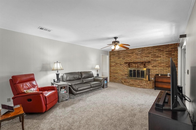 carpeted living area featuring visible vents, a brick fireplace, brick wall, and ceiling fan