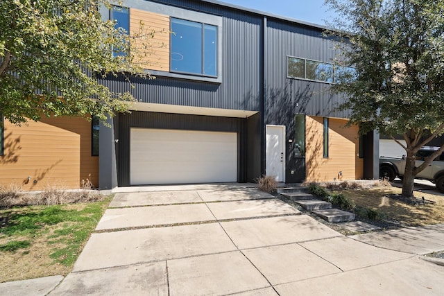 contemporary house with concrete driveway and a garage