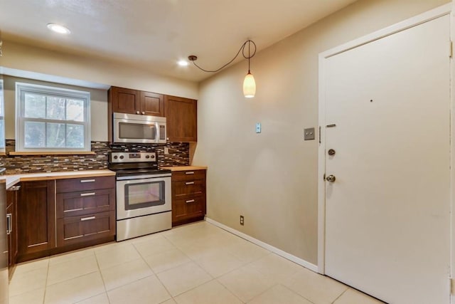 kitchen featuring tasteful backsplash, baseboards, light countertops, recessed lighting, and stainless steel appliances