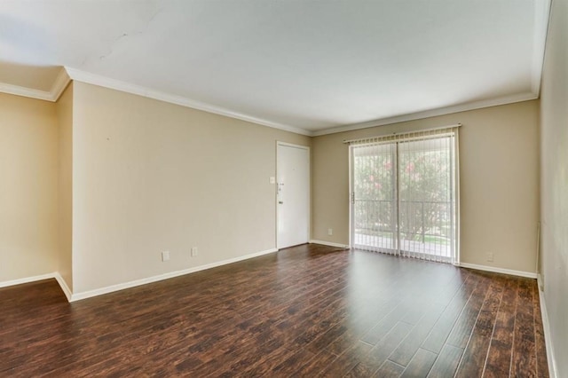 empty room featuring wood finished floors, baseboards, and ornamental molding