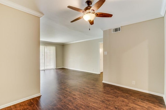 empty room with visible vents, crown molding, baseboards, a ceiling fan, and dark wood-style flooring