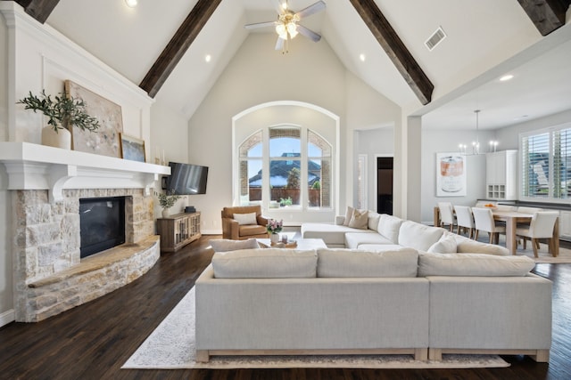 living area with a stone fireplace, beam ceiling, dark wood finished floors, and high vaulted ceiling