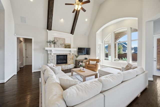 living area featuring high vaulted ceiling, baseboards, dark wood-type flooring, and a fireplace