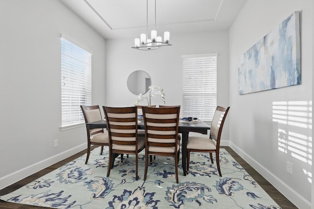 dining room featuring baseboards, an inviting chandelier, and wood finished floors