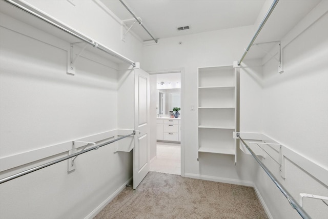 walk in closet featuring carpet and visible vents