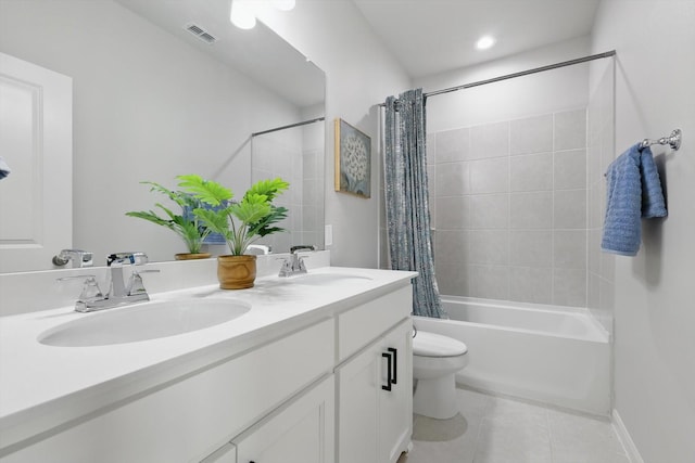 bathroom featuring tile patterned flooring, shower / tub combo, toilet, and a sink