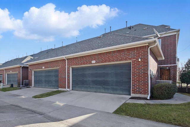 view of property exterior with brick siding, driveway, a shingled roof, and an attached garage