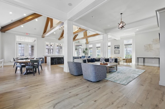 living room with baseboards, light wood finished floors, beam ceiling, recessed lighting, and a chandelier