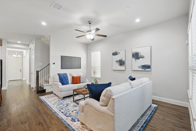 living room featuring dark wood-style floors, stairway, and baseboards