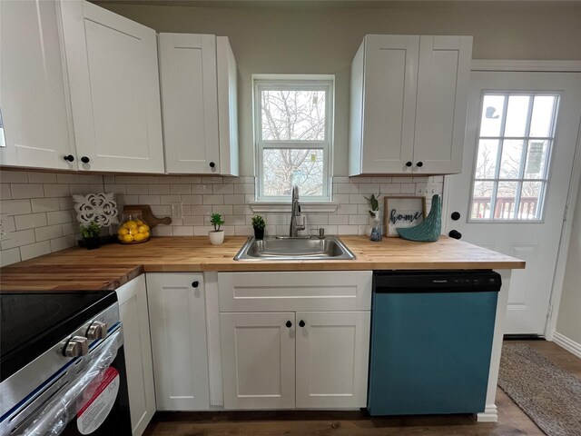 kitchen featuring dishwashing machine, butcher block counters, electric stove, and a sink