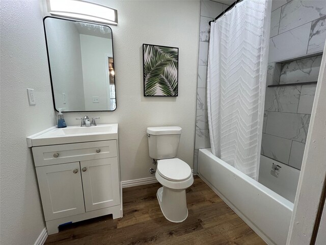 full bathroom with vanity, wood finished floors, baseboards, shower / bath combination with curtain, and toilet