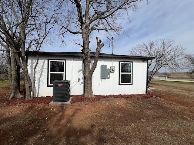 view of side of home featuring central AC unit