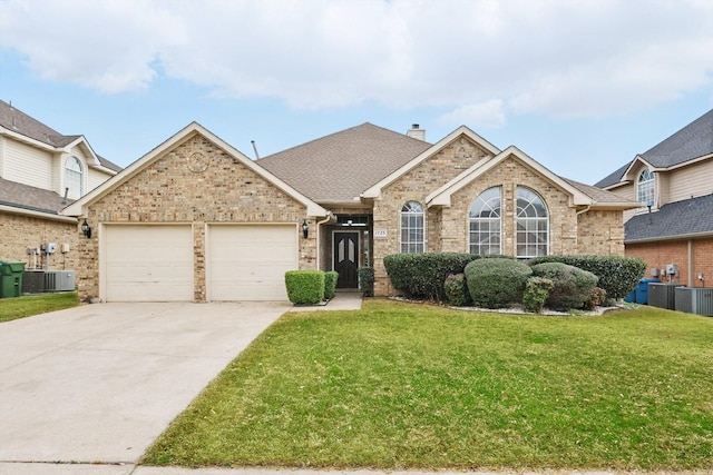 ranch-style home featuring an attached garage, a chimney, concrete driveway, a front lawn, and brick siding