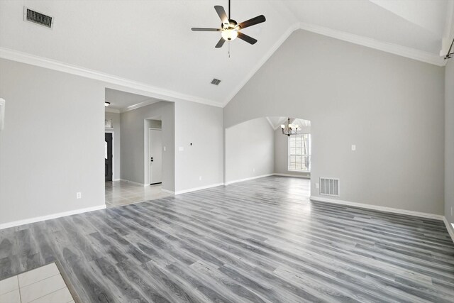 unfurnished living room featuring ceiling fan with notable chandelier, wood finished floors, visible vents, and ornamental molding