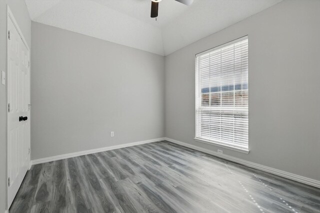 empty room featuring a ceiling fan, baseboards, and wood finished floors