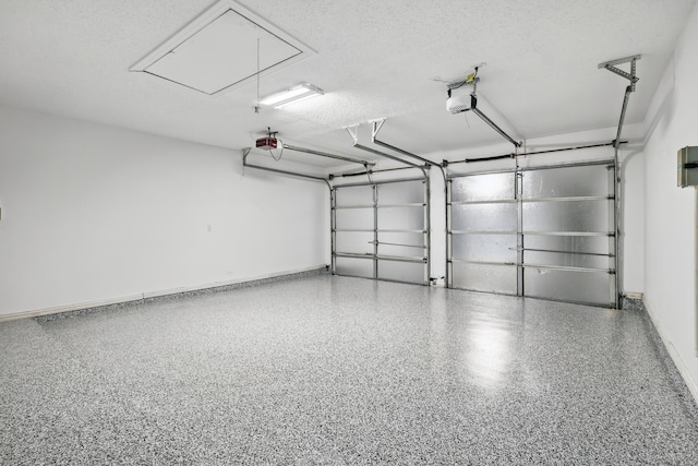 garage with a garage door opener and baseboards