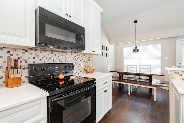 kitchen with dark wood finished floors, black appliances, light countertops, vaulted ceiling, and white cabinetry