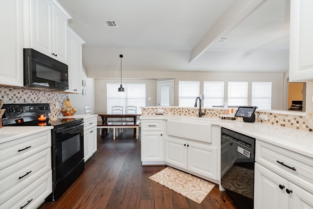 kitchen featuring visible vents, dark wood-style flooring, a sink, black appliances, and tasteful backsplash