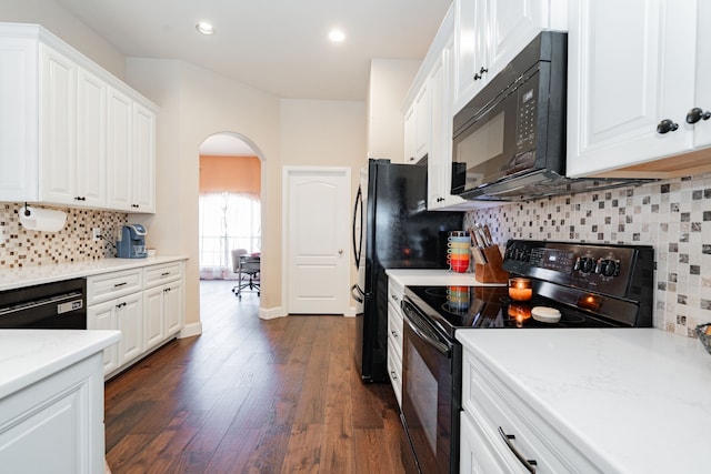 kitchen featuring black appliances, white cabinets, arched walkways, and dark wood-type flooring