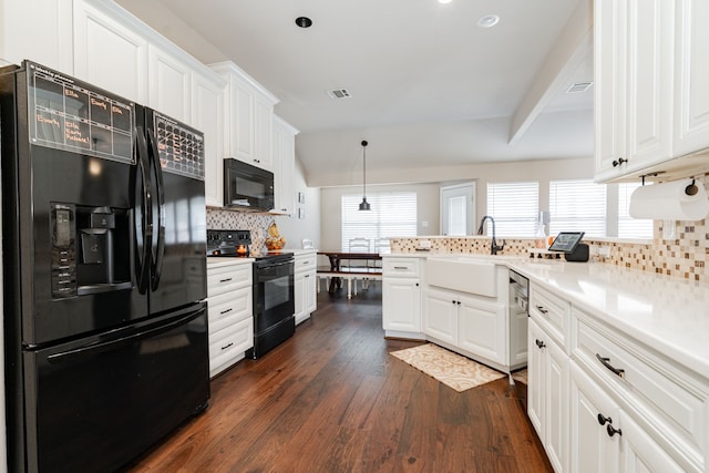 kitchen with visible vents, a sink, black appliances, white cabinetry, and dark wood-style flooring