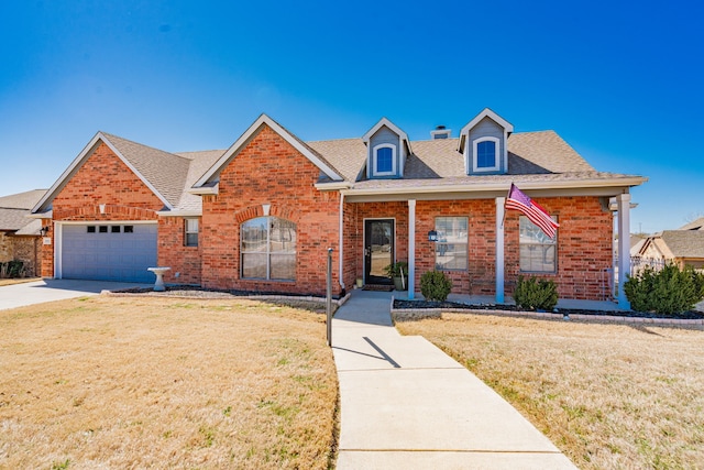 view of front of house featuring brick siding, a front yard, and a shingled roof