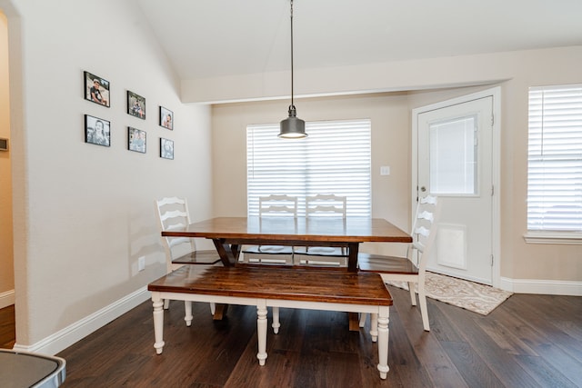 dining space with vaulted ceiling, dark wood-style floors, and baseboards