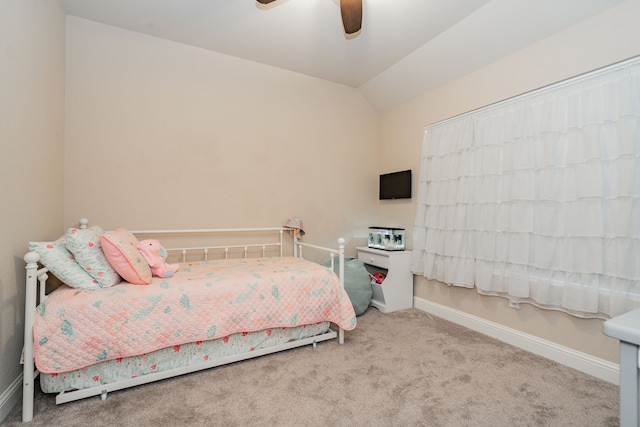 carpeted bedroom featuring vaulted ceiling, a ceiling fan, and baseboards