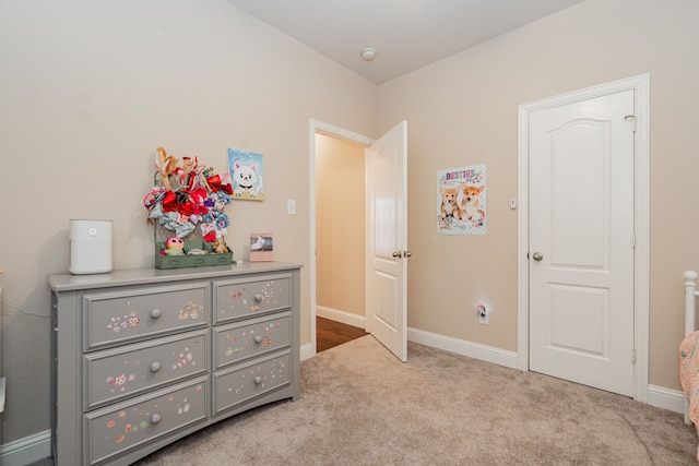 carpeted bedroom featuring baseboards