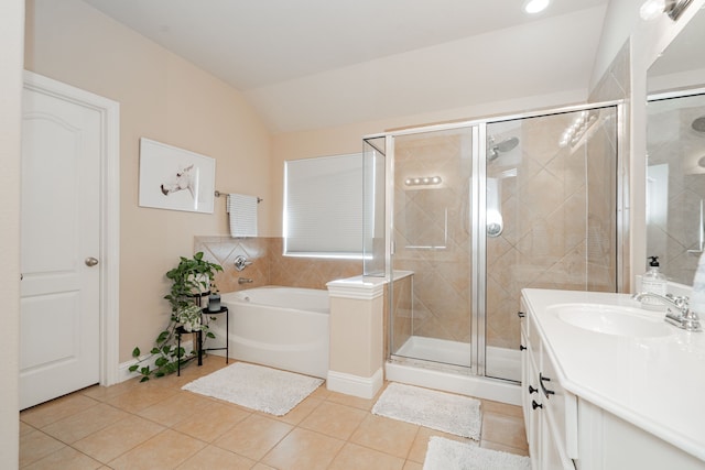 full bathroom featuring a garden tub, a stall shower, tile patterned flooring, lofted ceiling, and vanity