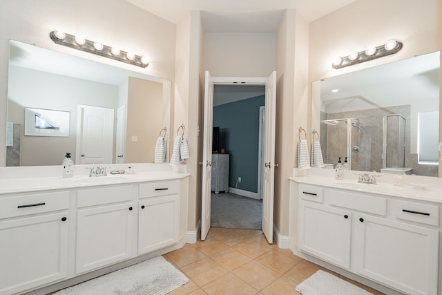 full bathroom featuring tile patterned floors, a shower stall, two vanities, and a sink